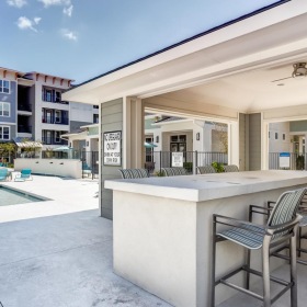 Settle into comfort at Atlantic at Parkridge a patio with chairs and bar seating outside