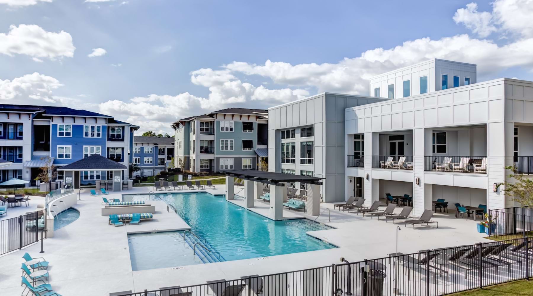 Resort-style swimming pool and lounge seating